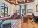 Office with a decorative wood ceiling, large windows, hardwood floors, and a custom desk at 1216 N Casey Key Rd, Osprey, FL 34229