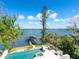 Aerial view of pool and dock with covered seating, set against the backdrop of the bay at 1216 N Casey Key Rd, Osprey, FL 34229