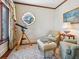 Cozy sitting room with a unique window, comfortable chairs, and telescope at 1216 N Casey Key Rd, Osprey, FL 34229
