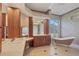 Bright bathroom featuring double sinks, wood cabinets, and a claw foot bathtub at 1355 Debrecen Rd, Sarasota, FL 34240