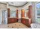 Elegant bathroom with double sinks, wood cabinets, and tile flooring at 1355 Debrecen Rd, Sarasota, FL 34240