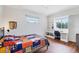 Bright bedroom with built-in shelving, desk and colorful basketball themed quilt at 1355 Debrecen Rd, Sarasota, FL 34240