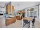 Spacious kitchen with island, wooden cabinets, black appliances, tile flooring, and an adjacent dining area at 1355 Debrecen Rd, Sarasota, FL 34240