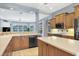 Open kitchen layout featuring an island, wooden cabinets, tile backsplash, and view to the outdoors at 1355 Debrecen Rd, Sarasota, FL 34240