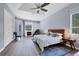 Primary bedroom showcasing a tray ceiling, built-in shelving, a fireplace, and access to a balcony at 1355 Debrecen Rd, Sarasota, FL 34240