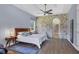 Spacious main bedroom with a stone accent wall, hardwood floors, and tray ceiling at 1355 Debrecen Rd, Sarasota, FL 34240