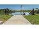 Backyard with serene lake views and lush landscaping. This home is an oasis of tranquility at 1416 41St E Ave, Ellenton, FL 34222