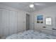 Bright bedroom featuring a white ceiling fan, dresser and closet at 1416 41St E Ave, Ellenton, FL 34222