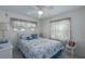 Cozy bedroom featuring a white wicker bed, ceiling fan, and window at 1416 41St E Ave, Ellenton, FL 34222
