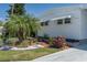 Charming detail shot of the home's exterior with lush landscaping and a mature palm tree at 1416 41St E Ave, Ellenton, FL 34222