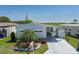 Charming single-story home with covered parking, landscaping, and a clear blue sky at 1416 41St E Ave, Ellenton, FL 34222