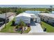 Charming home featuring lush landscaping and a covered carport, situated by a serene lake at 1416 41St E Ave, Ellenton, FL 34222