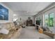 Bright living room featuring a comfortable sofa, a ceiling fan, and large windows at 1416 41St E Ave, Ellenton, FL 34222