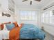 Bright bedroom featuring coastal decor, white shelving, and a ceiling fan at 144 Harrison Dr, Sarasota, FL 34236