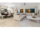Open-concept living room and dining area featuring hardwood floors and ample natural light at 144 Harrison Dr, Sarasota, FL 34236