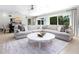Open-concept living and dining room featuring a large sectional sofa and access to the backyard and pool at 144 Harrison Dr, Sarasota, FL 34236