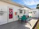 Relaxing patio with outdoor seating, white facade, and clear blue sky at 144 Harrison Dr, Sarasota, FL 34236