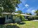 Charming single-story home with a well-manicured lawn, blooming tree, and a durable metal roof providing curb appeal at 1507 30Th W St, Bradenton, FL 34205