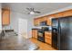Cozy kitchen featuring wooden cabinets, black appliances, and tile flooring at 1507 30Th W St, Bradenton, FL 34205