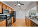 Traditional kitchen with wooden cabinets, tile floors, and black appliances at 1507 30Th W St, Bradenton, FL 34205