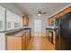 Open kitchen with wood cabinets, tile flooring, and a view into the living room at 1507 30Th W St, Bradenton, FL 34205