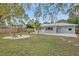 Spacious backyard featuring a cozy fire pit area, landscaping, and private fencing at 1507 30Th W St, Bradenton, FL 34205