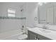 Cozy bathroom with white subway tiles, modern vanity, and bathtub with shower at 1507 30Th W St, Bradenton, FL 34205