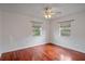 This bedroom features hardwood floors, neutral walls, and bright natural light from two windows at 1507 30Th W St, Bradenton, FL 34205