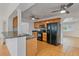 Kitchen showcasing oak cabinets, a black refrigerator, and bar seating to an open living area at 1507 30Th W St, Bradenton, FL 34205
