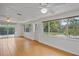 Bright living room featuring large windows, neutral walls, and tile flooring overlooking the yard at 1507 30Th W St, Bradenton, FL 34205