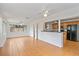 Open-concept living room with large windows and tile flooring leading to a kitchen at 1507 30Th W St, Bradenton, FL 34205