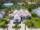 Stunning aerial view of a luxurious home with a tile roof, lush landscaping, and waterfront access at 1575 Eastbrook Dr, Sarasota, FL 34231