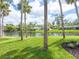 The backyard boasts a tranquil water view surrounded by lush, tropical landscaping at 1575 Eastbrook Dr, Sarasota, FL 34231