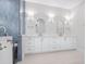 Bathroom with dual sinks, white cabinets, and walk in shower at 1575 Eastbrook Dr, Sarasota, FL 34231