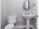 Charming powder room featuring pedestal sink and stylish fixtures at 1575 Eastbrook Dr, Sarasota, FL 34231
