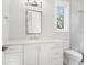 Bathroom boasts white cabinetry, modern fixtures, and a serene window view at 1575 Eastbrook Dr, Sarasota, FL 34231