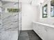 Modern bathroom featuring a glass walk-in shower and dual sink vanity at 1575 Eastbrook Dr, Sarasota, FL 34231