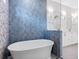 Bathroom showcasing a standalone tub and blue accent tiling at 1575 Eastbrook Dr, Sarasota, FL 34231