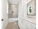 Well-lit bathroom features marble shower, quartz counters, and classic fixtures at 1575 Eastbrook Dr, Sarasota, FL 34231