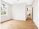 Well-lit room with hardwood floors and view of a kitchen at 1575 Eastbrook Dr, Sarasota, FL 34231
