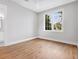 Bright bedroom featuring a large window and hardwood floors at 1575 Eastbrook Dr, Sarasota, FL 34231