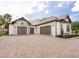 An attractive home features a three-car garage and a beautiful paver driveway at 1575 Eastbrook Dr, Sarasota, FL 34231