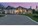 Stunning home featuring stone accents, manicured landscaping, arched entry and paver circular driveway at 1575 Eastbrook Dr, Sarasota, FL 34231