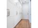 Hallway features white storage cabinets with metal handles and hardwood floors at 1575 Eastbrook Dr, Sarasota, FL 34231