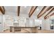 Bright kitchen featuring wooden beam ceiling, pendant lights, hardwood floors and modern cabinets at 1575 Eastbrook Dr, Sarasota, FL 34231