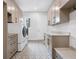 Laundry room featuring side by side washer and dryer and custom cabinetry at 1575 Eastbrook Dr, Sarasota, FL 34231