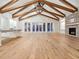 Bright open concept living room with wood beam ceiling, hardwood flooring, and fireplace at 1575 Eastbrook Dr, Sarasota, FL 34231