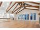 Spacious living room with hardwood floors, vaulted ceilings, and open floor plan leading to the kitchen at 1575 Eastbrook Dr, Sarasota, FL 34231