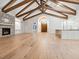 Spacious open concept living room with stone fireplace, wood beam ceiling, and hardwood flooring at 1575 Eastbrook Dr, Sarasota, FL 34231