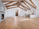 Bright and spacious living room with wood floors, vaulted ceilings with beams, and a stone fireplace at 1575 Eastbrook Dr, Sarasota, FL 34231